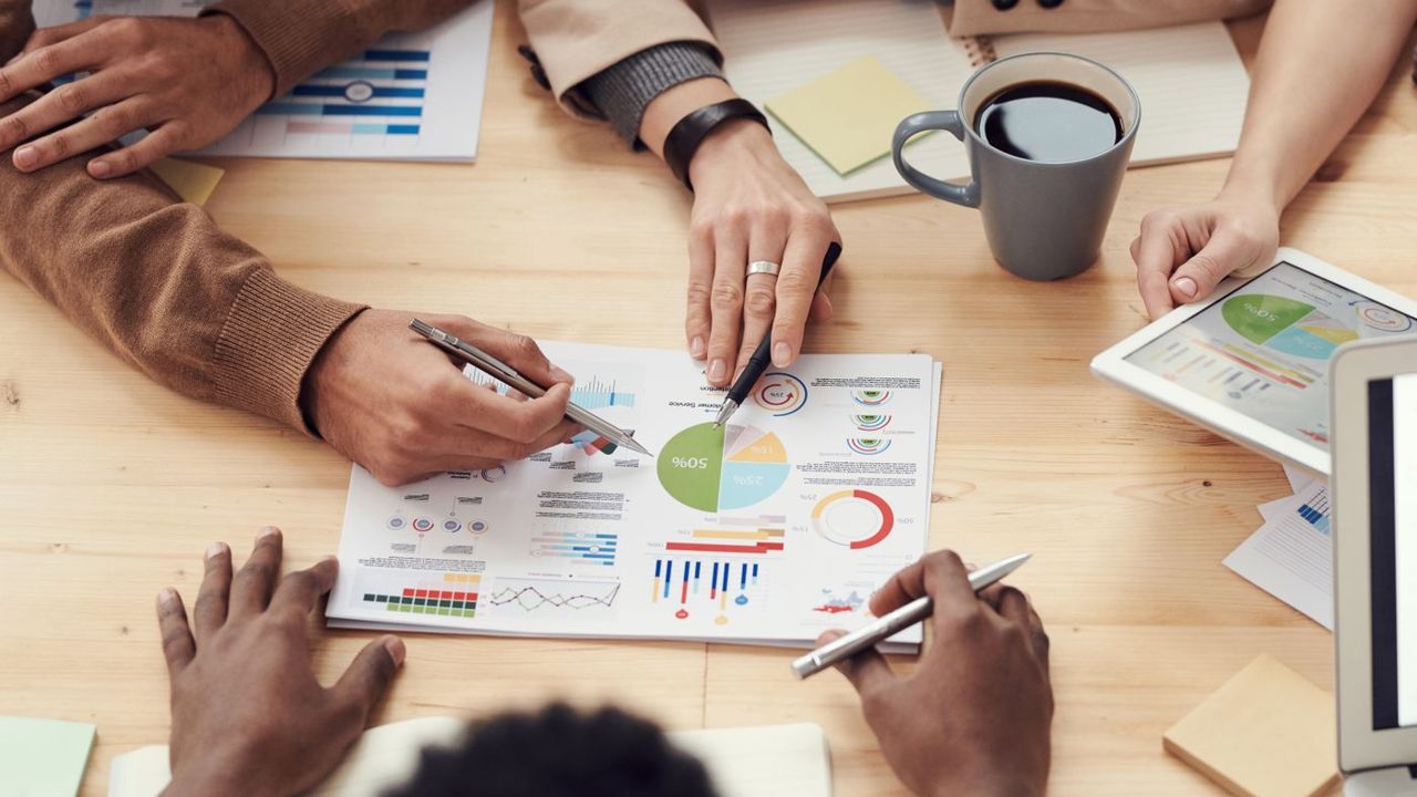 Researchers analysing charts and market data during expert sourcing