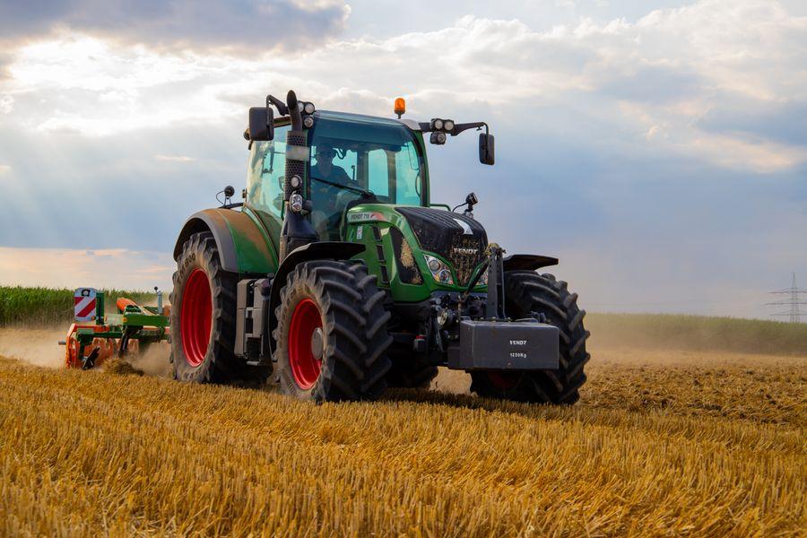 Tractor in a field representing food and agriculture coverage